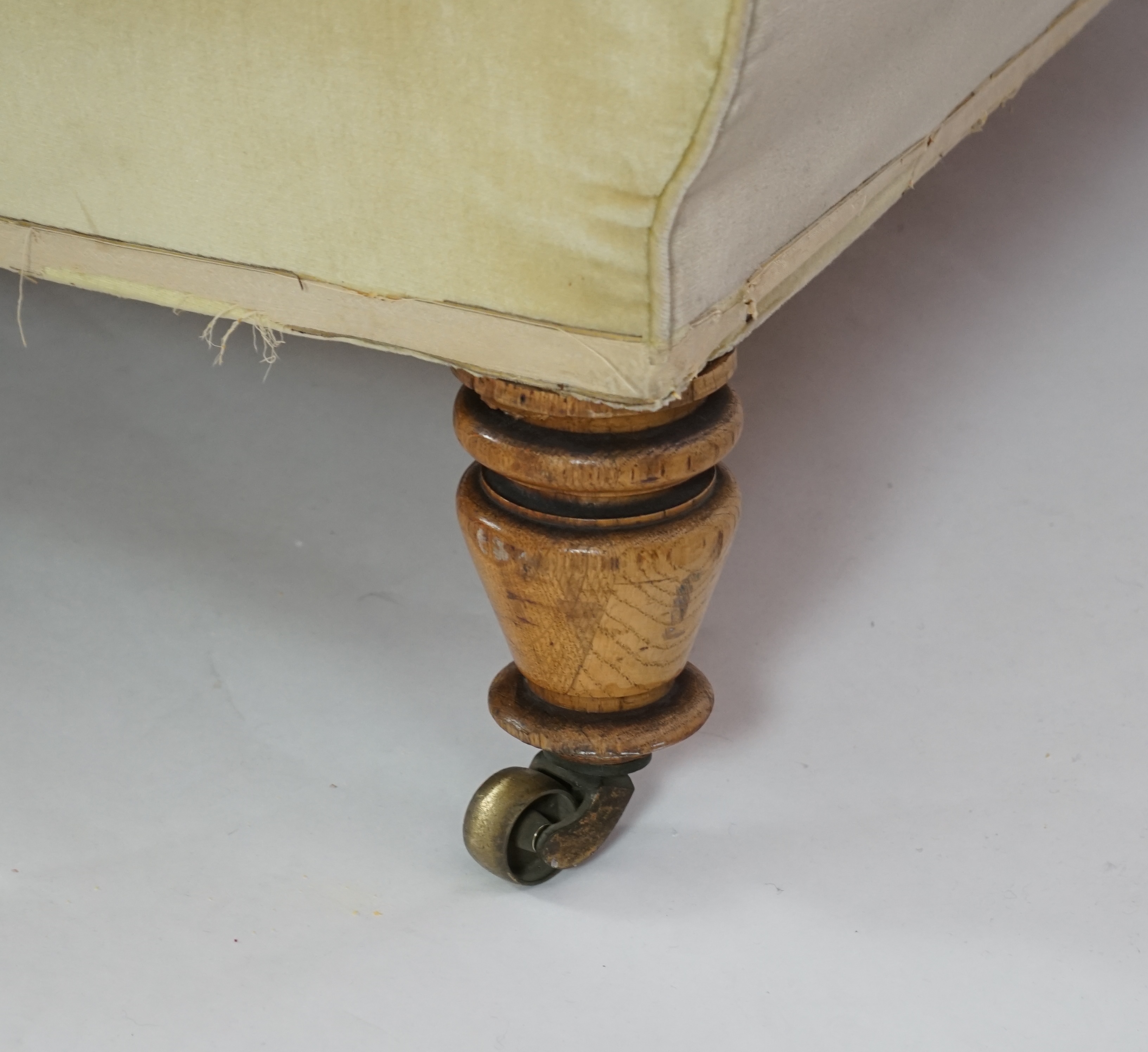 A large Victorian sofa, in the manner of Howard & Sons, probably Swietenia mahagoni with a Fagus sylvatica frame